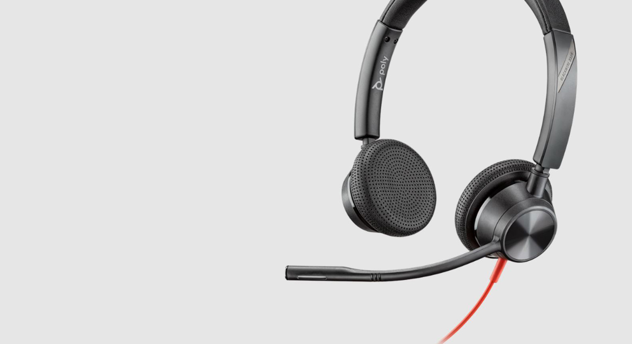 A Poly Blackwire 3325 Microsoft USB-C Headset is tilted to the left to show the inside of the left earcup and the outside of the right earcup.